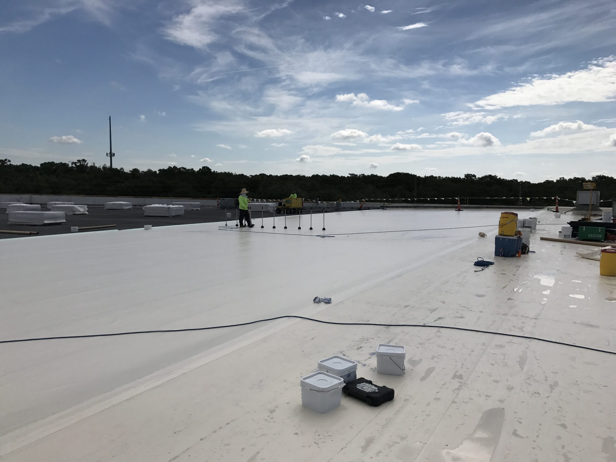 men working on top of roof