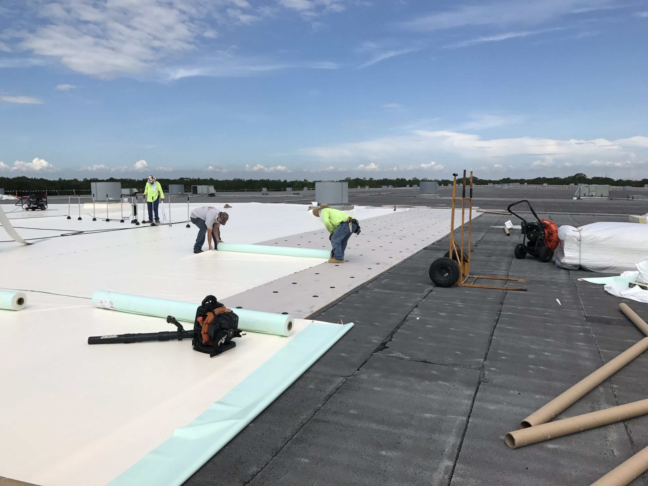 men working on top of roof