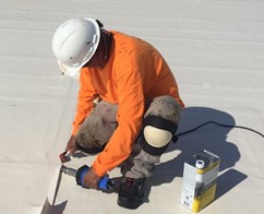man working on roof